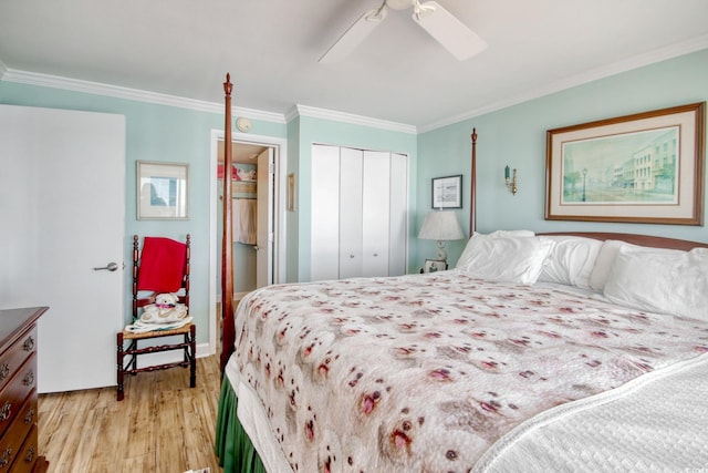 bedroom featuring ceiling fan, light hardwood / wood-style floors, ornamental molding, and a closet