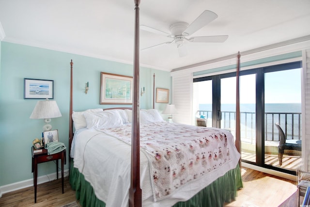 bedroom with ceiling fan, a water view, wood-type flooring, and access to outside