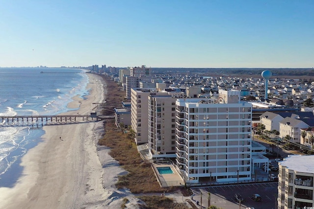 birds eye view of property featuring a water view and a view of the beach