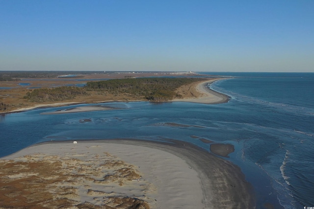 drone / aerial view featuring a water view and a view of the beach