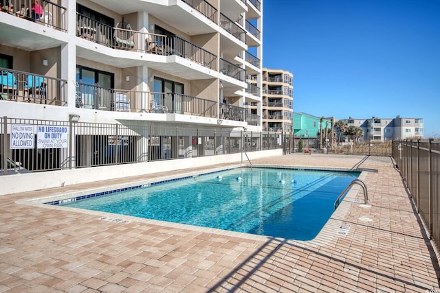 view of swimming pool with a patio