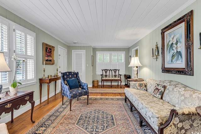 living room with a wealth of natural light, hardwood / wood-style floors, crown molding, and wooden ceiling