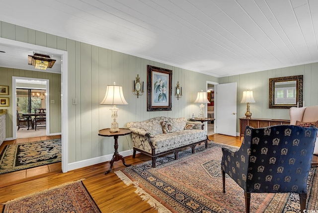 living room featuring wooden walls, light hardwood / wood-style flooring, and wooden ceiling