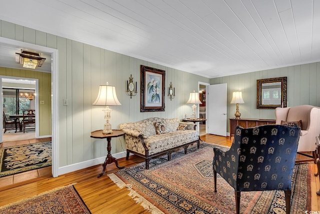 living room with hardwood / wood-style flooring, wood ceiling, and wooden walls