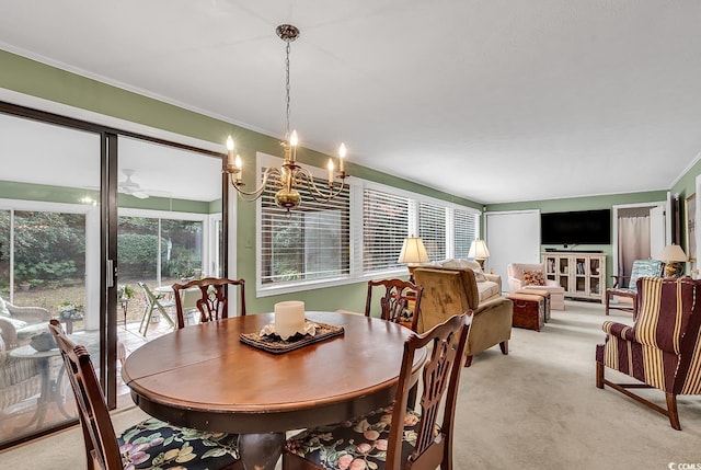 dining area featuring light carpet, plenty of natural light, a chandelier, and ornamental molding