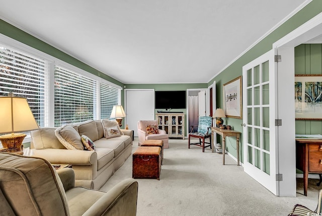 carpeted living room with ornamental molding