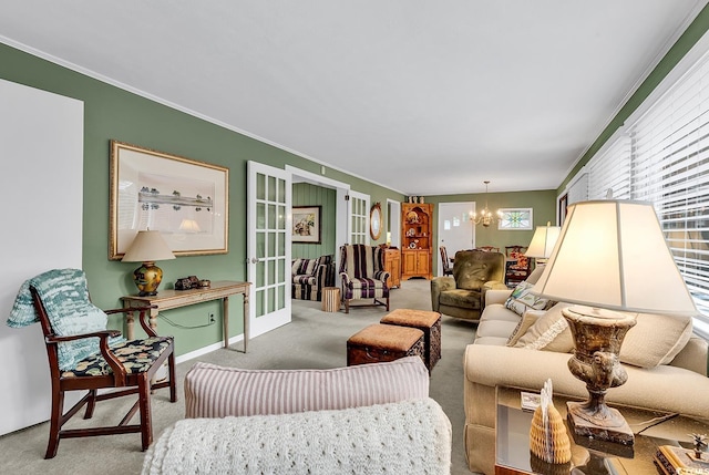 carpeted living room featuring french doors, ornamental molding, and an inviting chandelier