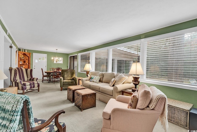 carpeted living room with a notable chandelier