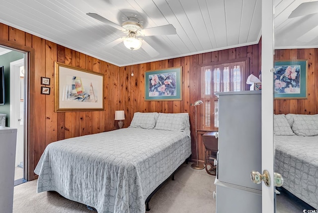 carpeted bedroom with ceiling fan, crown molding, and wood ceiling