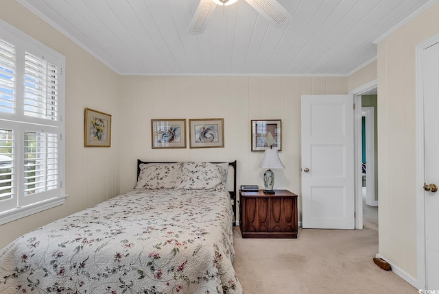 bedroom with ceiling fan, light colored carpet, crown molding, and multiple windows