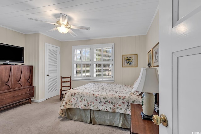 bedroom featuring light colored carpet, ceiling fan, and crown molding