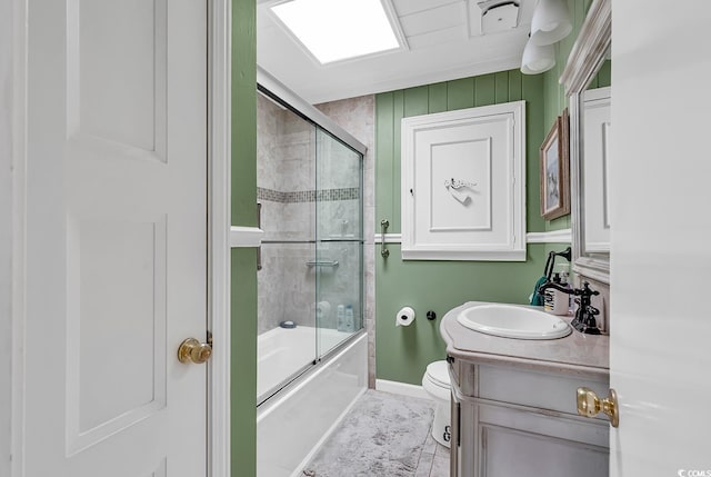 full bathroom with shower / bath combination with glass door, vanity, toilet, and tile patterned flooring