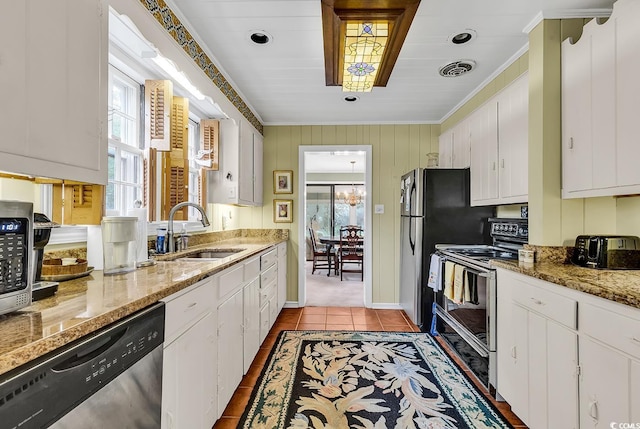 kitchen with dishwasher, electric range, white cabinetry, and light stone counters