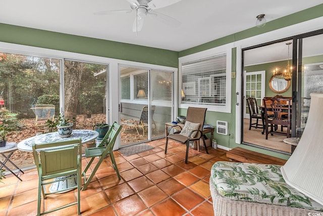 sunroom / solarium featuring a wall mounted air conditioner and ceiling fan