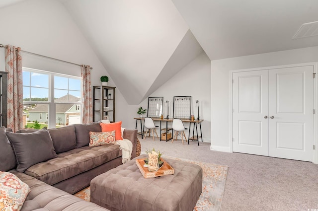 carpeted living room featuring vaulted ceiling