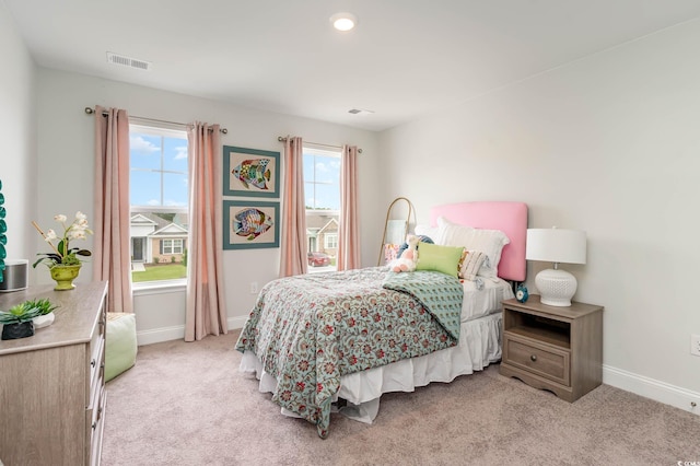 bedroom featuring light carpet