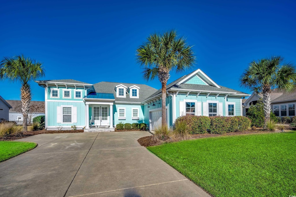 view of front of property with a front yard and a garage