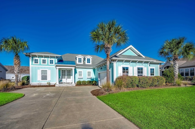 view of front of property with a front yard and a garage