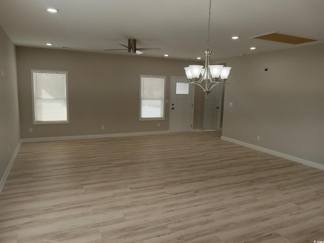 empty room featuring recessed lighting, a wealth of natural light, and light wood finished floors