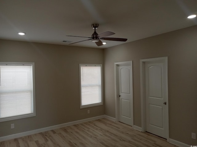 unfurnished bedroom featuring recessed lighting, a ceiling fan, light wood-style floors, visible vents, and baseboards