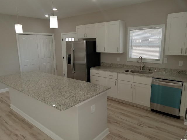 kitchen with a sink, white cabinets, dishwasher, and stainless steel fridge with ice dispenser