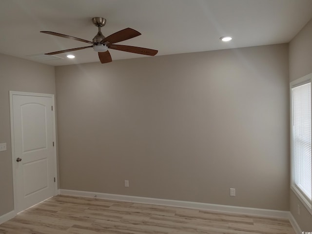 empty room with recessed lighting, baseboards, and light wood-style floors