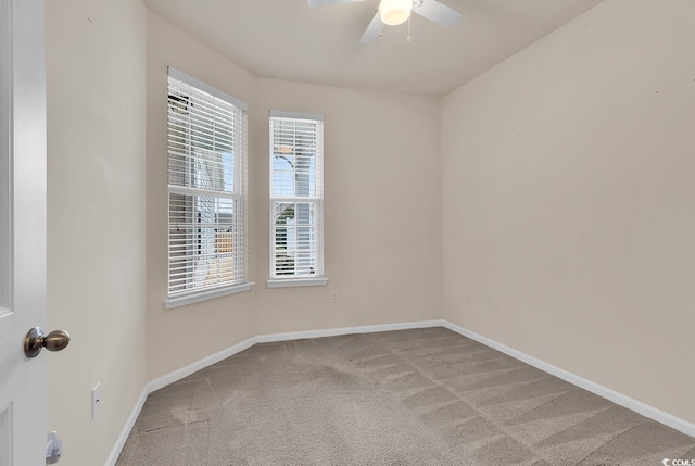 spare room featuring ceiling fan and light carpet