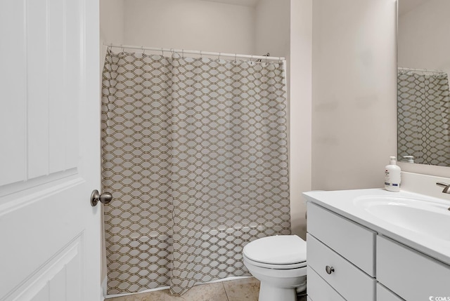 bathroom with toilet, tile patterned flooring, and vanity