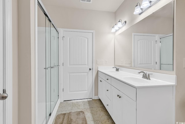 bathroom with vanity and an enclosed shower