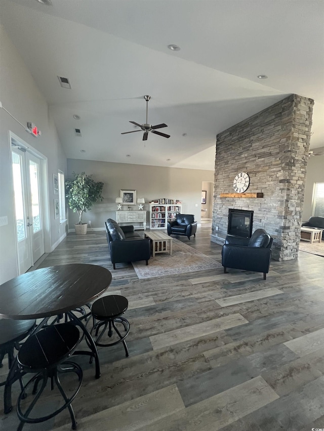 living room with ceiling fan, a fireplace, wood-type flooring, high vaulted ceiling, and french doors