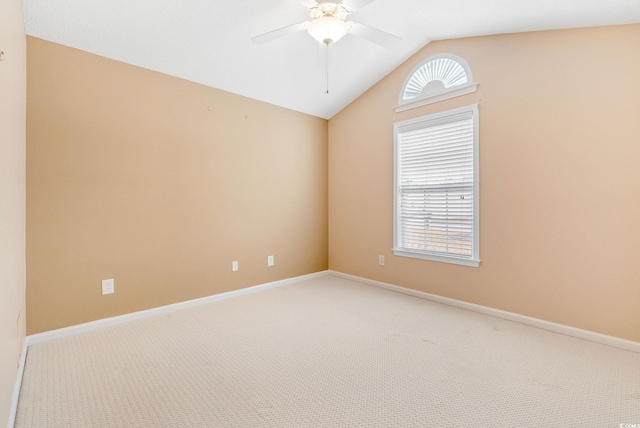 carpeted empty room featuring ceiling fan and vaulted ceiling