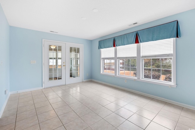 tiled spare room with french doors