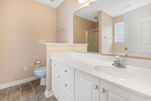 bathroom with vanity, toilet, and walk in shower