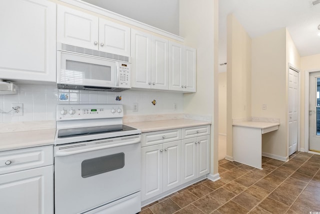 kitchen with tasteful backsplash, white cabinets, and white appliances