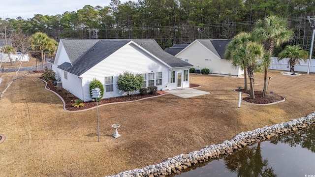 exterior space with a water view and a yard