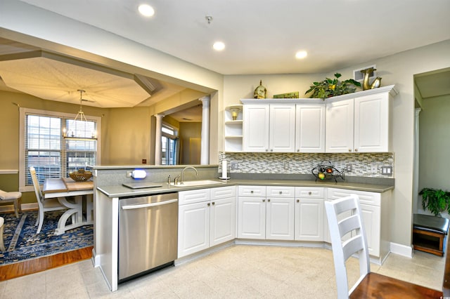 kitchen featuring white cabinetry, dishwasher, sink, tasteful backsplash, and pendant lighting