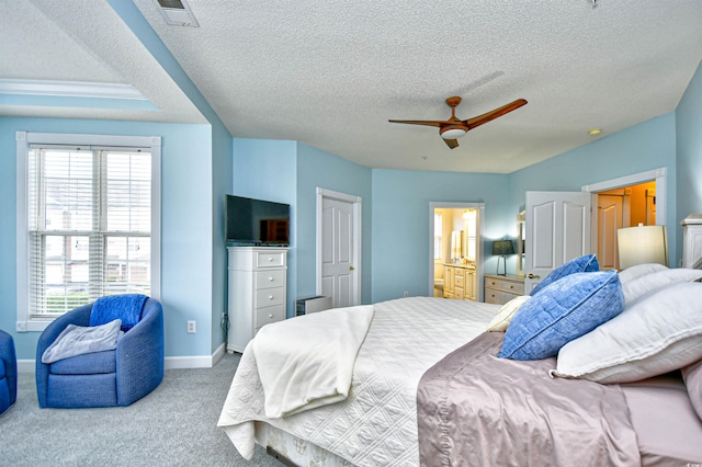 carpeted bedroom with ceiling fan and a textured ceiling