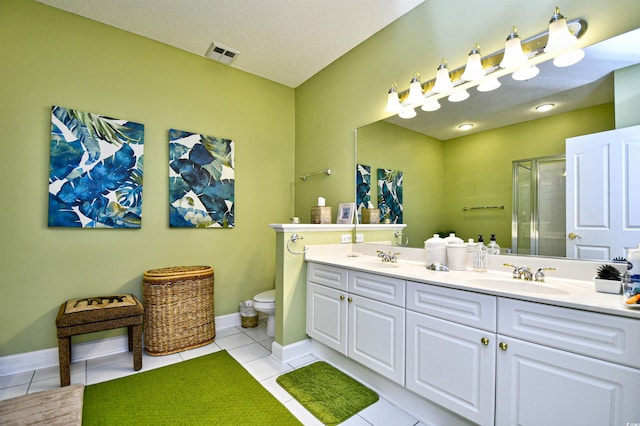 bathroom featuring tile patterned flooring, toilet, an enclosed shower, and vanity