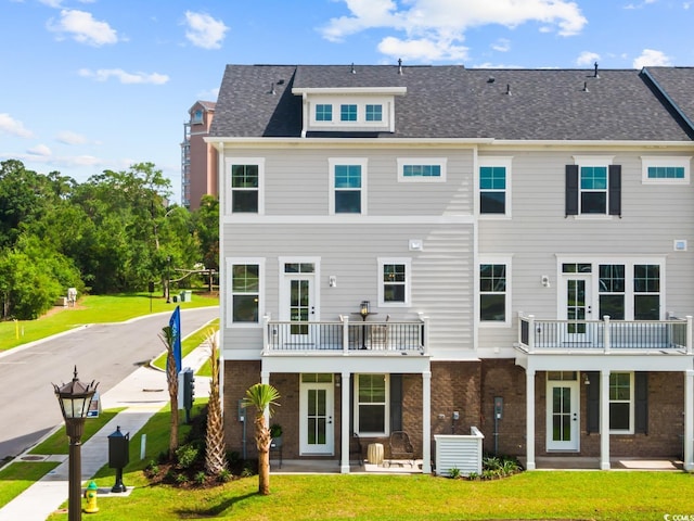 8411 Flamingo Ct Unit 7, Myrtle Beach, SC 29572 - back of house with brick siding and a lawn