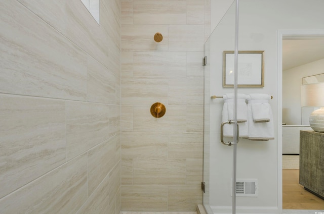 bathroom with a shower with shower door