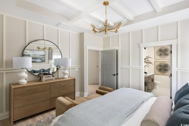 8476 Duke Pl Unit 32, Myrtle Beach, SC 29572 - bedroom with a chandelier, beam ceiling, light wood-style floors, and ensuite bath