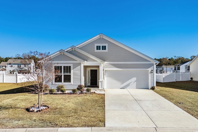 view of front of home with a front yard and a garage