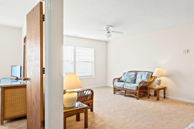 living area featuring ceiling fan and light carpet