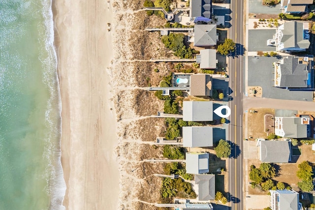 birds eye view of property featuring a view of the beach and a water view