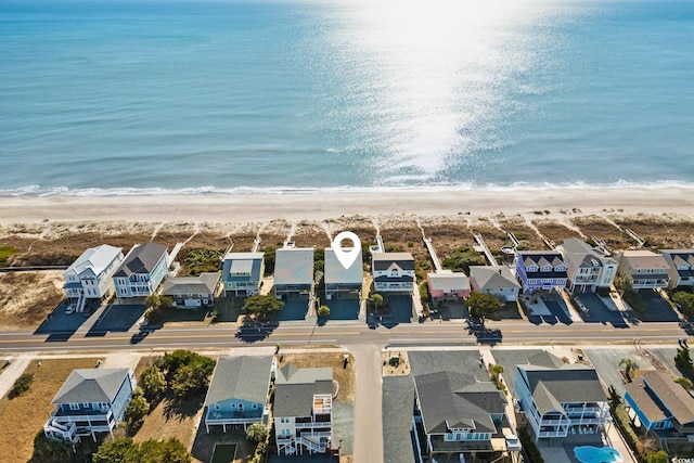 bird's eye view with a water view and a beach view