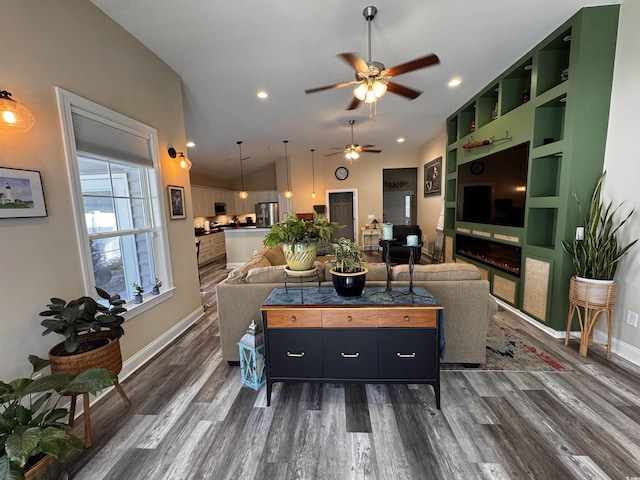 living area with dark wood finished floors, lofted ceiling, recessed lighting, a ceiling fan, and baseboards