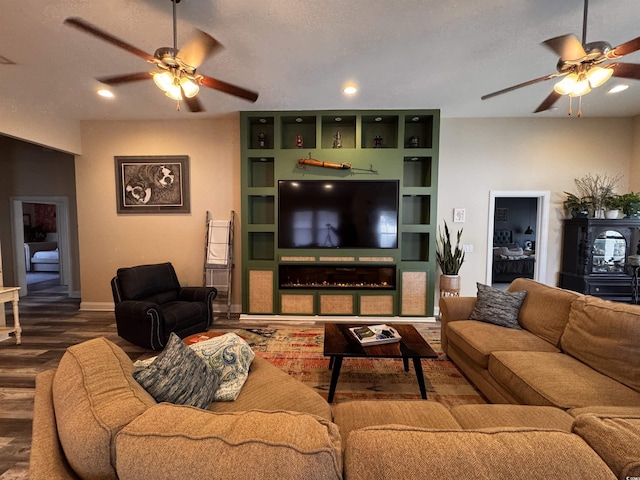 living room with built in shelves, recessed lighting, ceiling fan, and wood finished floors