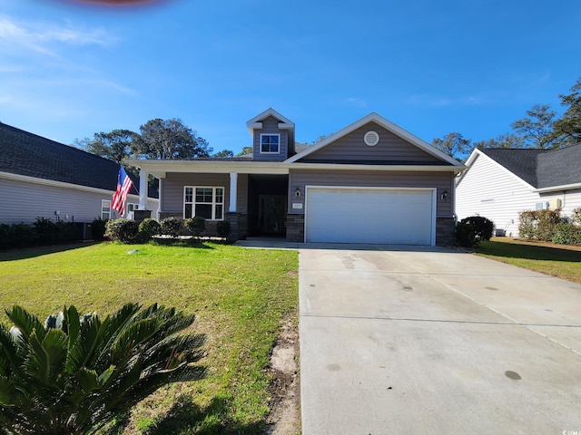 view of front of property with stone siding, an attached garage, driveway, and a front lawn