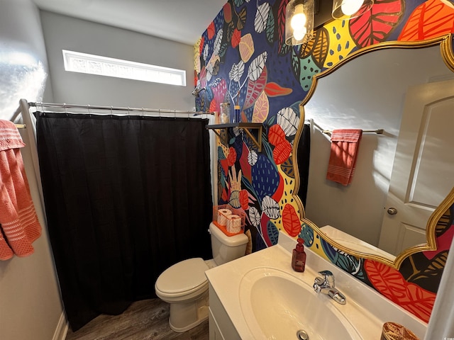 bathroom with a shower with shower curtain, vanity, toilet, and wood finished floors