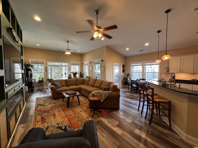 living room featuring plenty of natural light, dark wood-type flooring, and recessed lighting